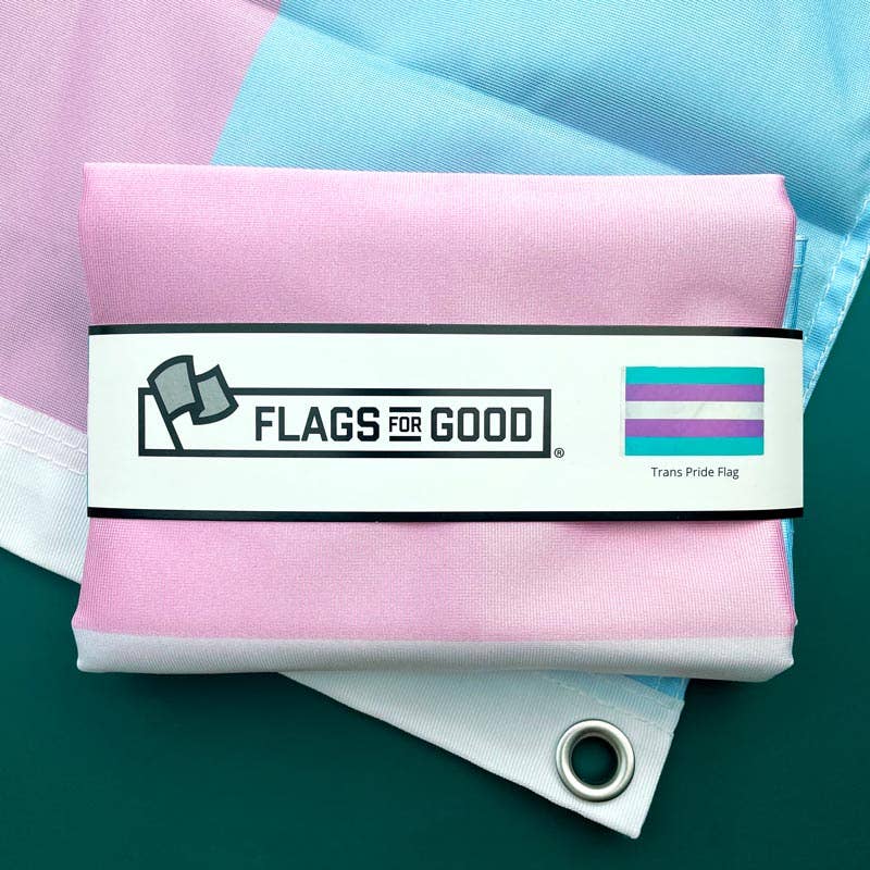 Trans flag with 'Flags for Good' label and trans pride flag on a green background