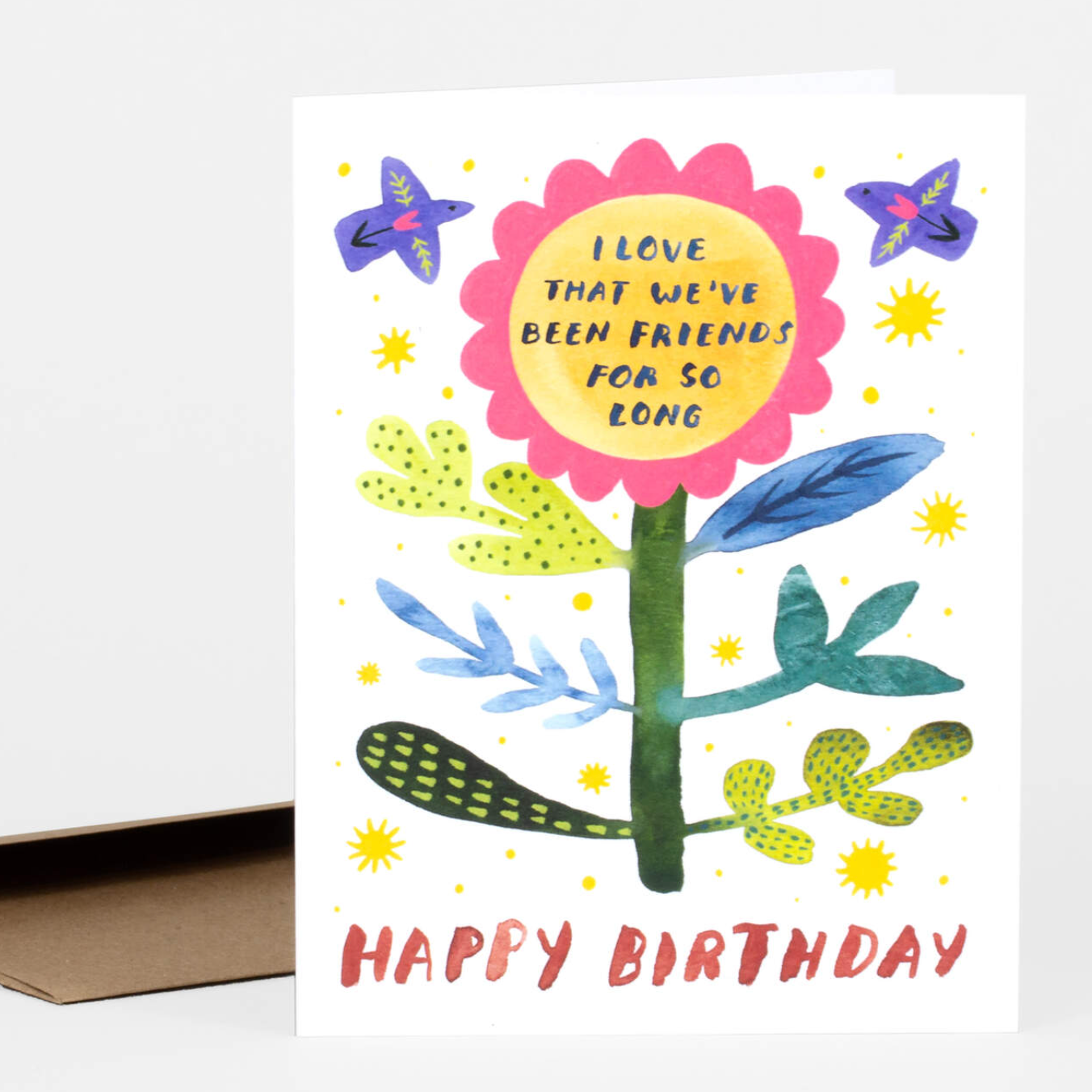 Greeting card with a large flower in the center and two abstract birds flying around it. The bottom says "Happy Birthday"