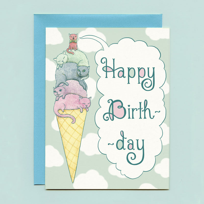 A card that says "Happy Birthday" in a speech bubble and has an illustration of cats in a pile on top of an ice cream cone. 