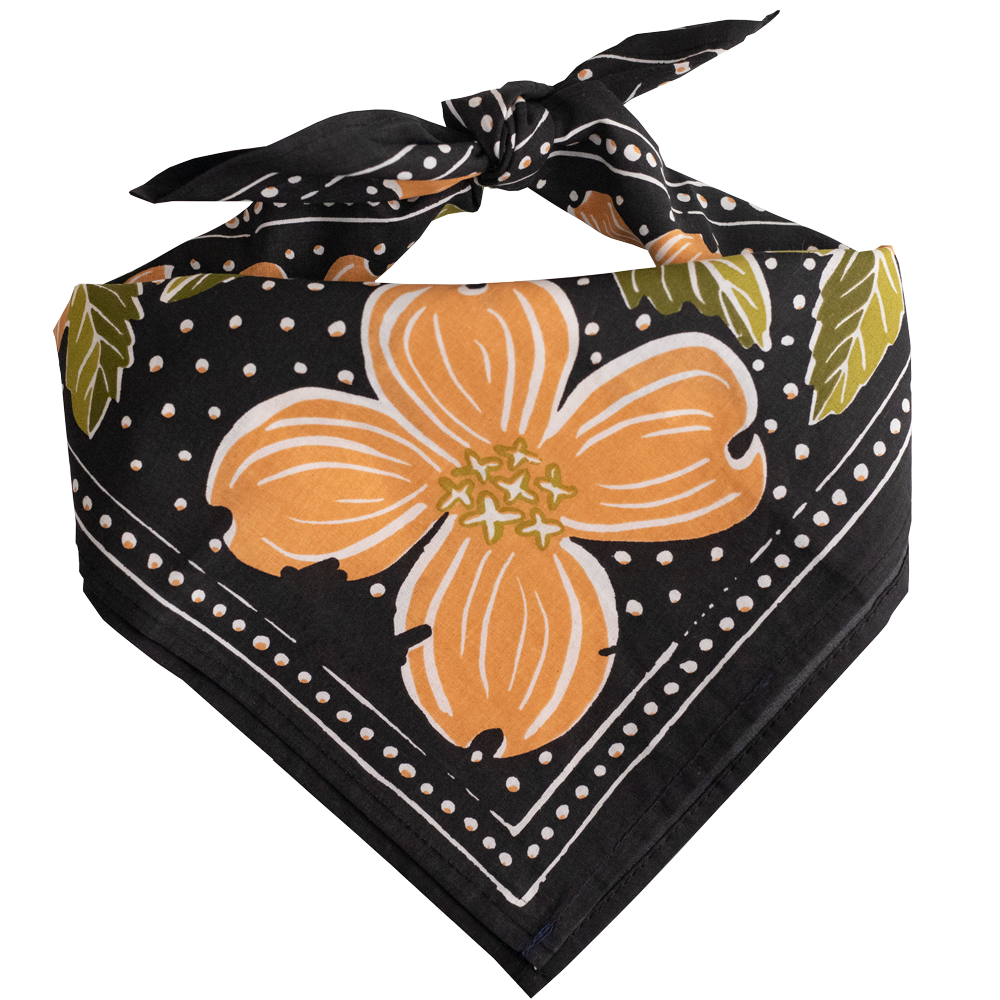 Gray bandana with peach colored flowers and green leaves tied into a scarf.