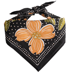 Gray bandana with peach colored flowers and green leaves tied into a scarf.