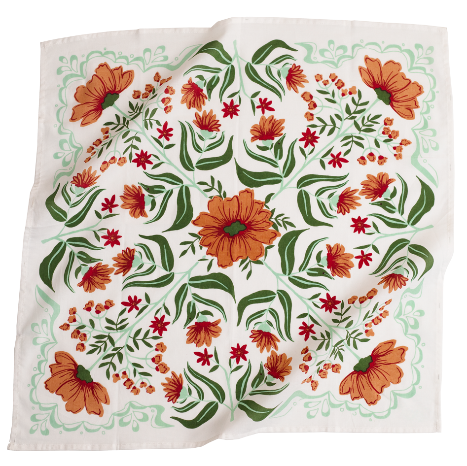White bandana with a orange and green floral pattern. 