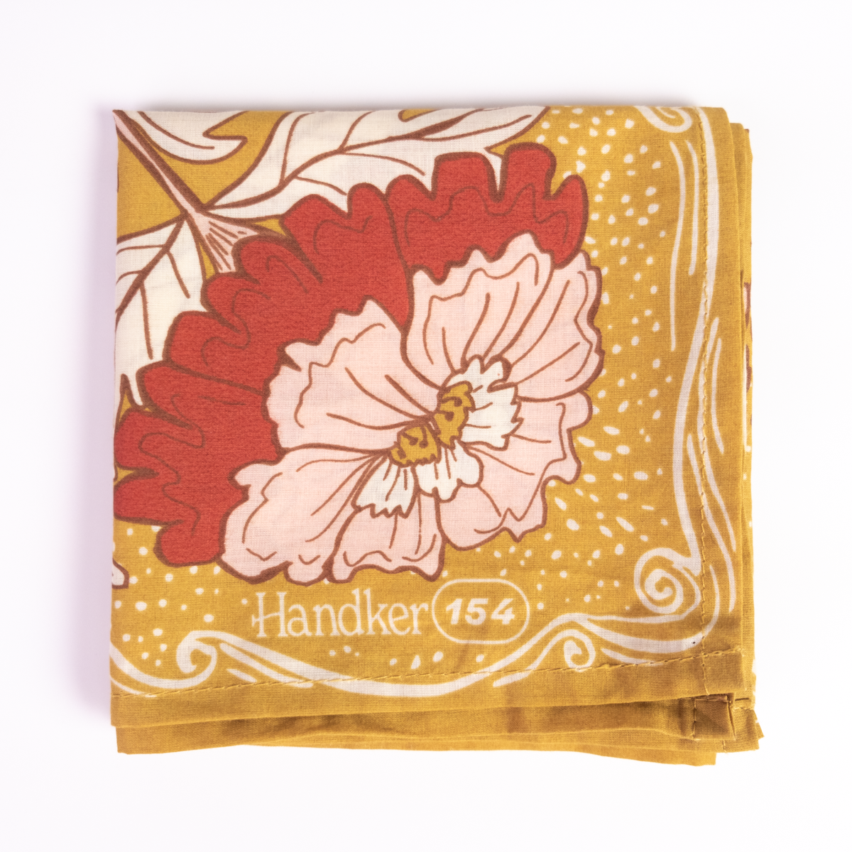 Floral patterned bandana folded into a small square, showing a closeup of a red and pink flower.