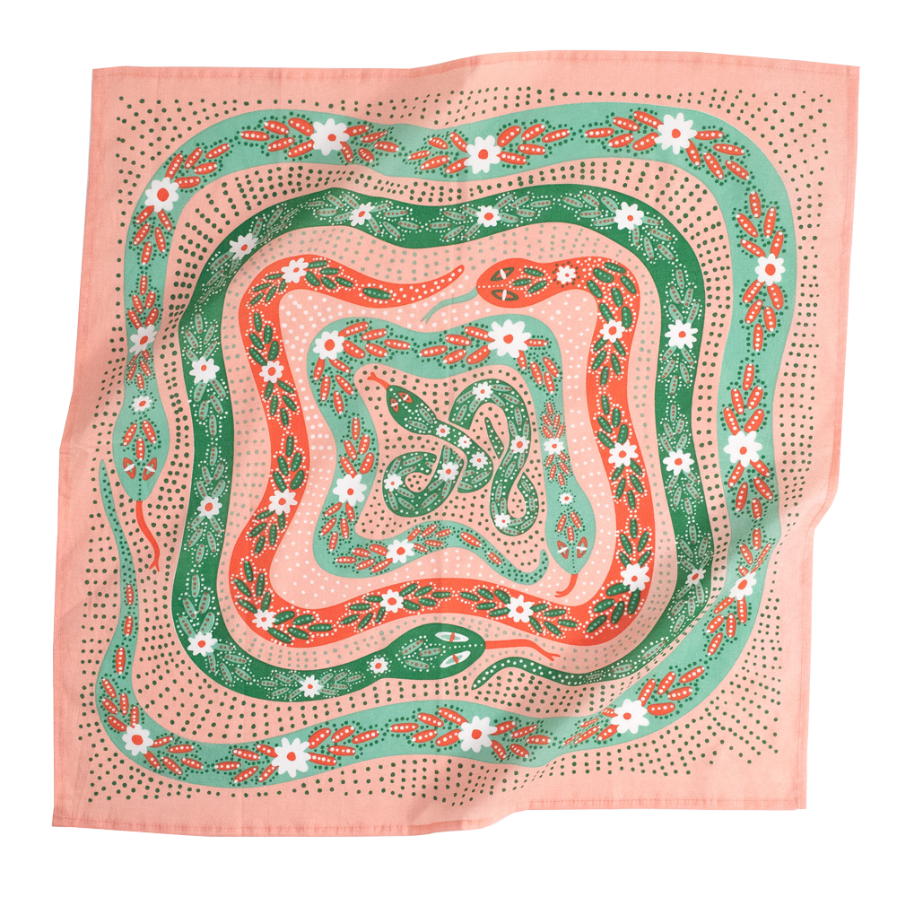 A pink bandana with a design of snakes in various shades of green and orange with floral patterns on them. 