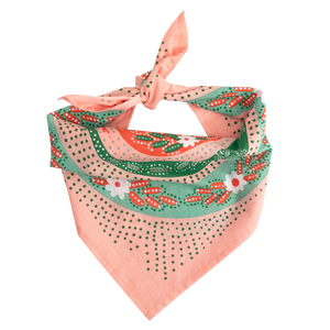 Pink patterned bandana folded and tied into a scarf. 