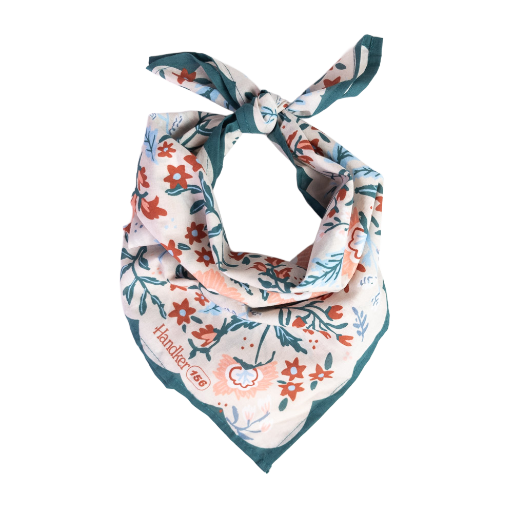 A floral patterned bandana folded and tied into a neck scarf.