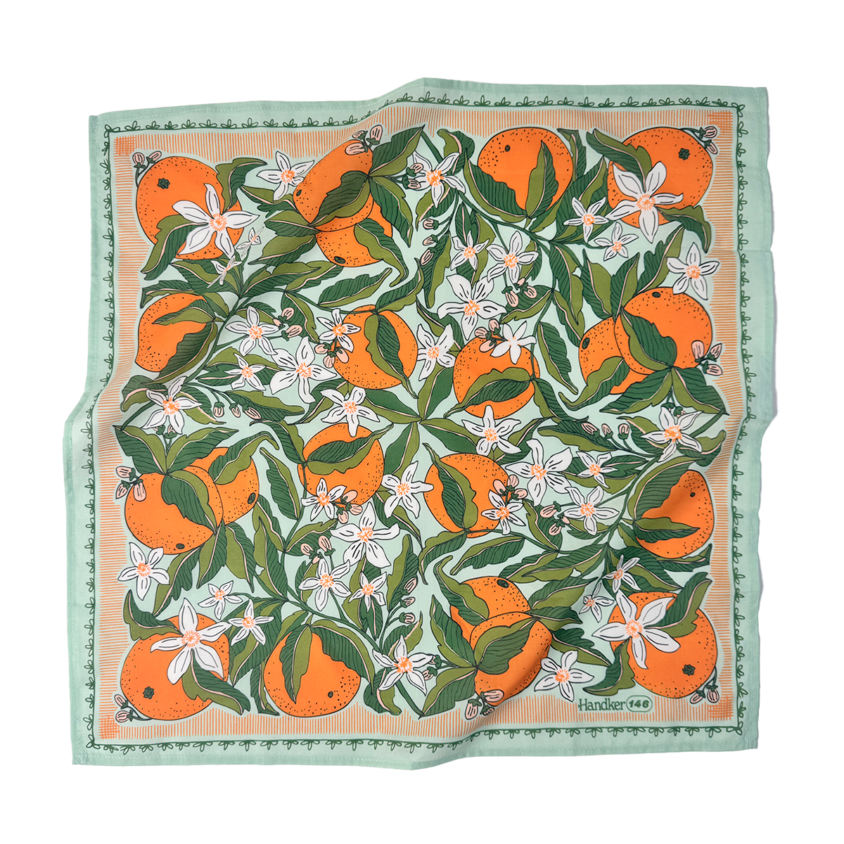 A mint-colored bandana with a pattern of oranges and orange blossoms. 