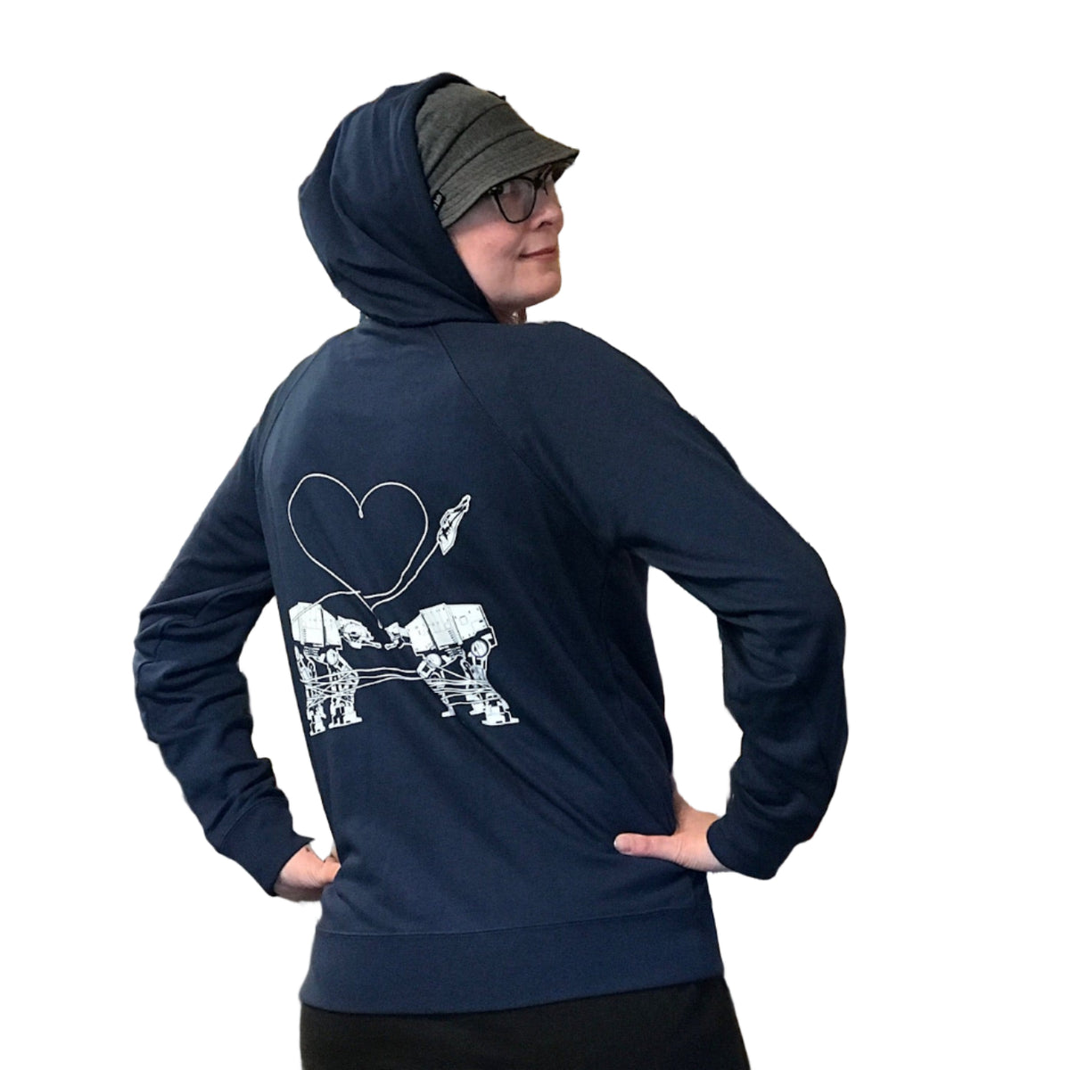 Person wearing a navy hoodie with the Love AT-AT First Sight design in a store setting.