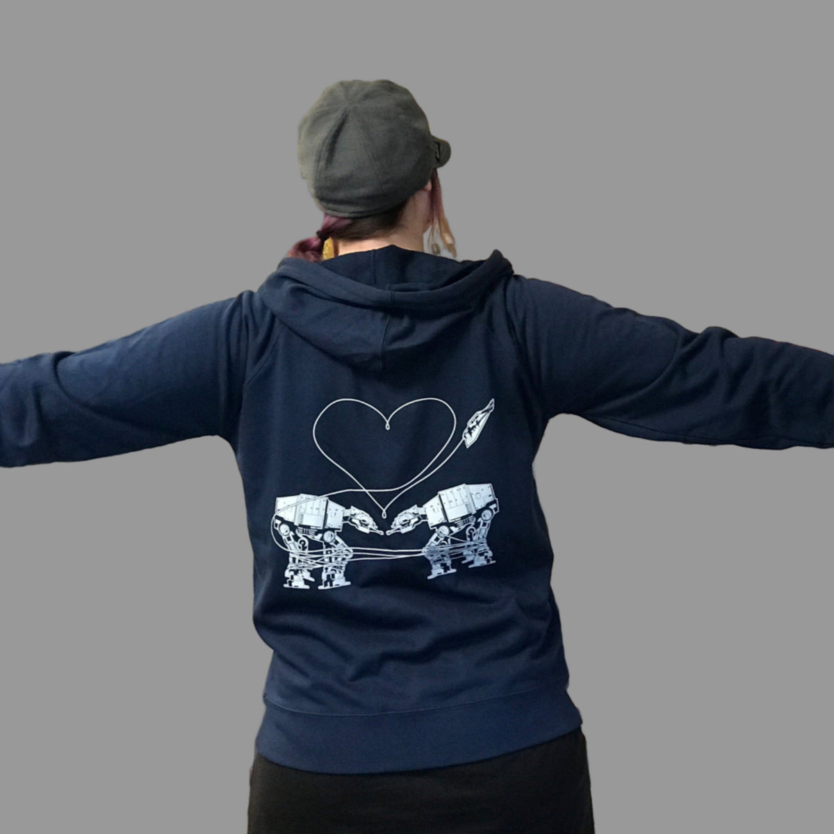 Person wearing a blue hoodie with a the Love AT-AT First Sight design in a store setting. 