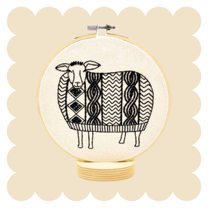 Sheep design in an embroidery hoop on a beige background