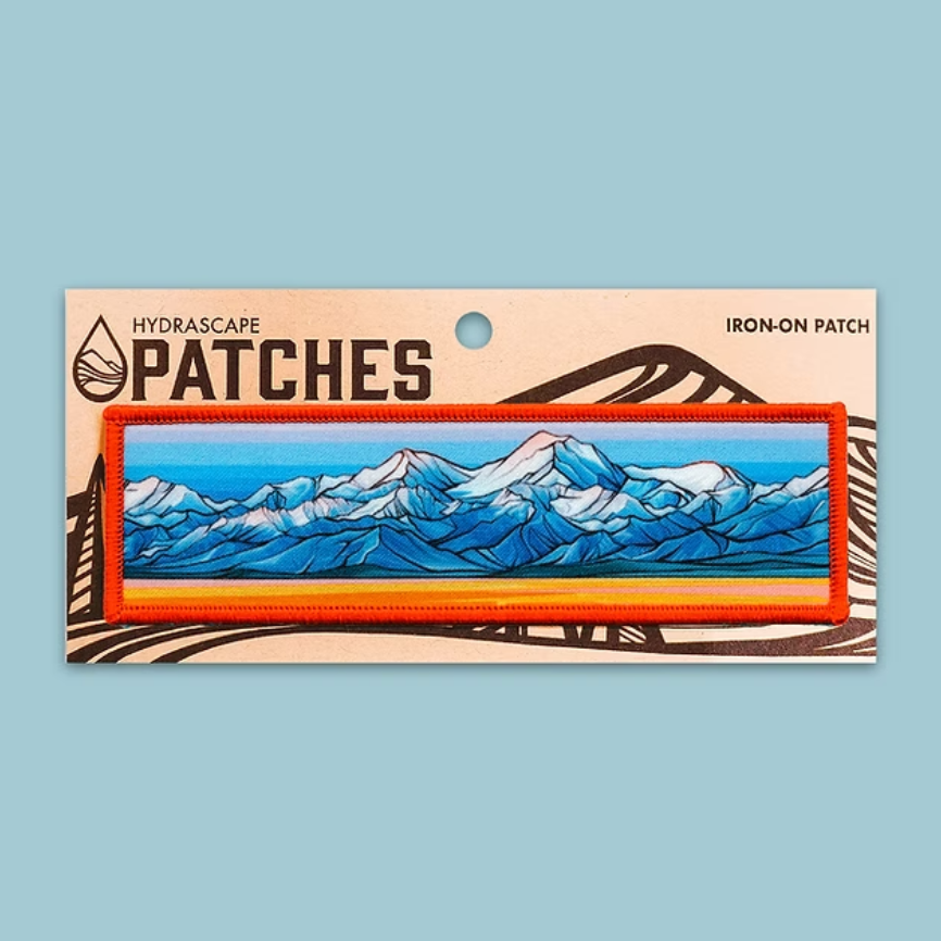 Iron-on patch with mountain design on a blue background