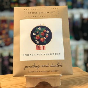 The packaging for the Spread Like Strawberries kit by Junebug & Darlin. It is a brown kraft paper envelope with a photograph of the finished kit on the front. 