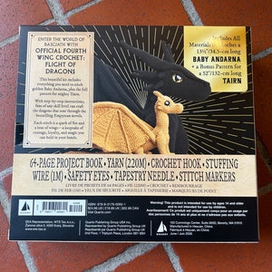 Back cover of a craft project kit titled  laid flat on a red textured surface. The cover features a black background with two crochet dragons and a cream title panel with product details and publisher information.