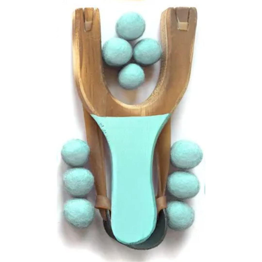 Wooden slingshot with turquoise handle and multiple turquoise balls on a white background