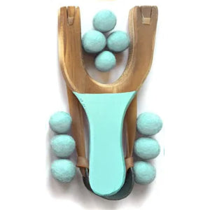 Wooden slingshot with turquoise handle and multiple turquoise balls on a white background