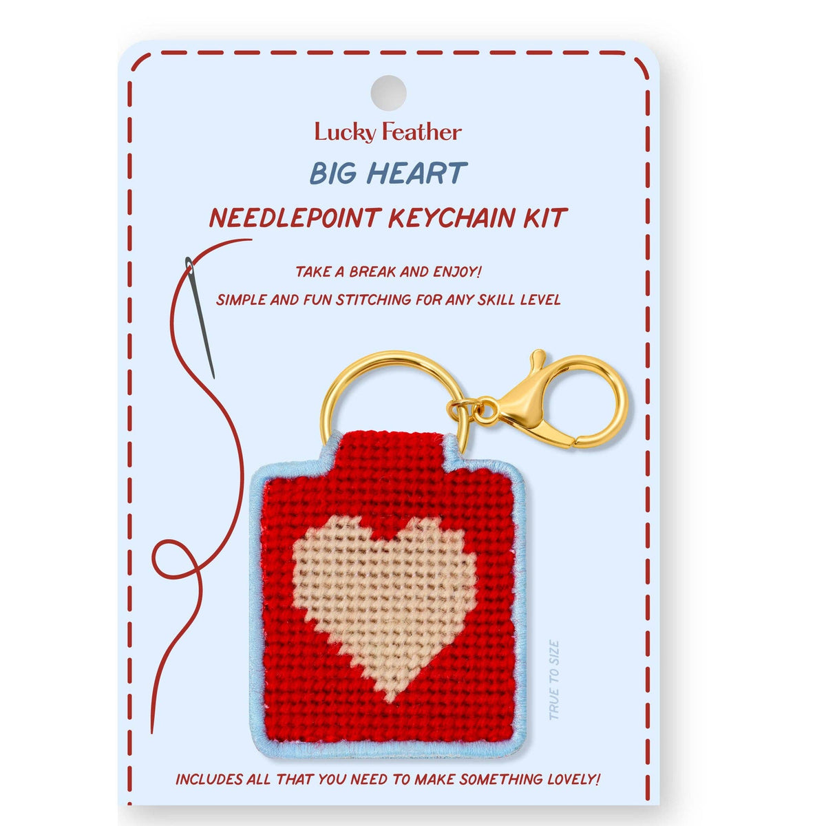 Craft kit of a needlepoint keychain featuring a design of a pink heart on a red background 
