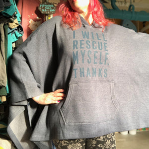 Person wearing a navy blue hoodie with text that says "I will rescue myself, thanks" in a store setting. 