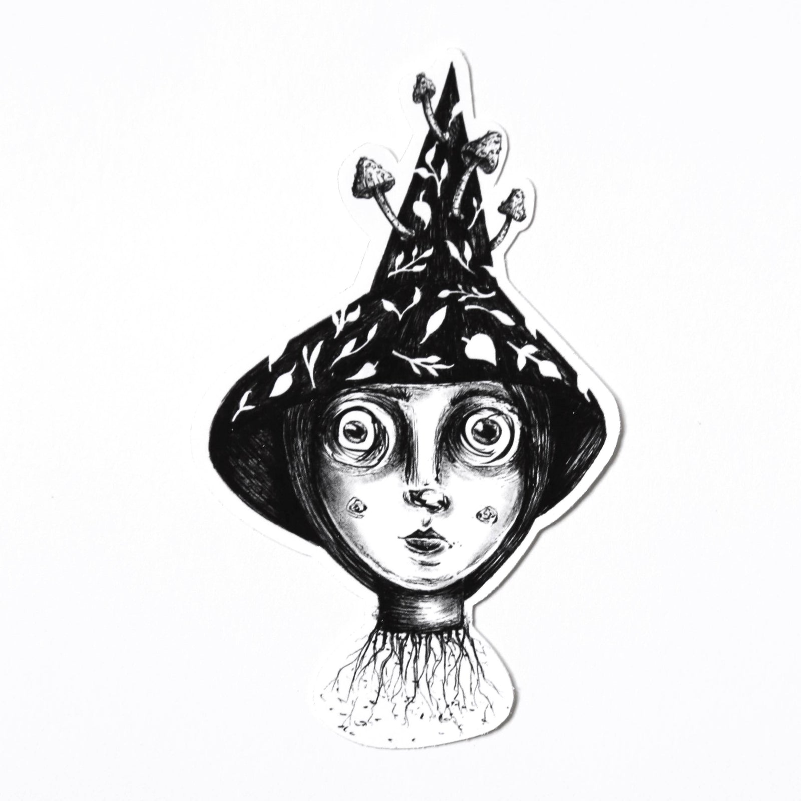 Illustrated black and white sticker of a witch's head wearing a pointy hat with mushrooms coming out of it and roots coming out of her neck