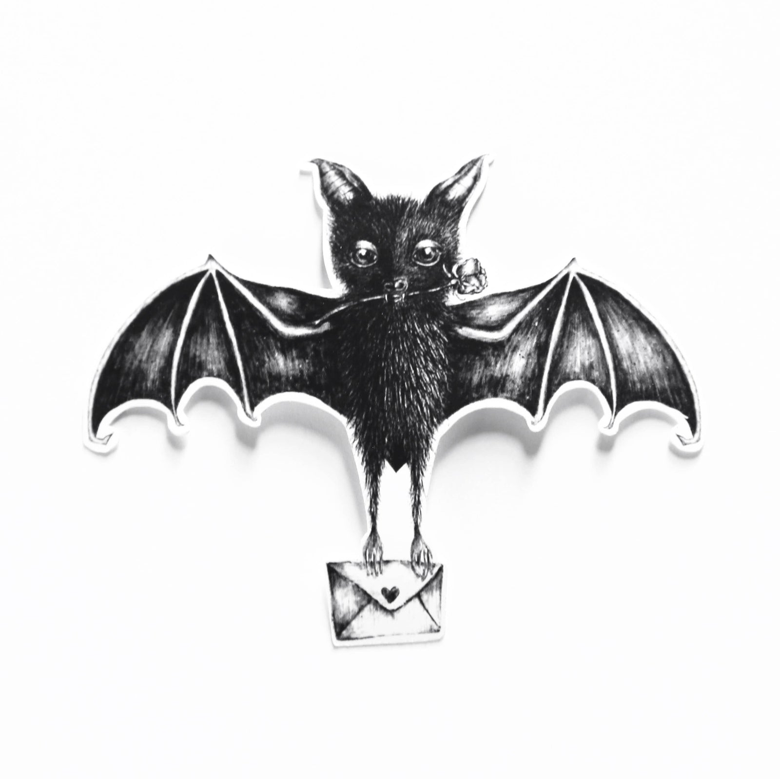 A black and white bat-shaped sticker holding a small envelope, shown against a plain white background.