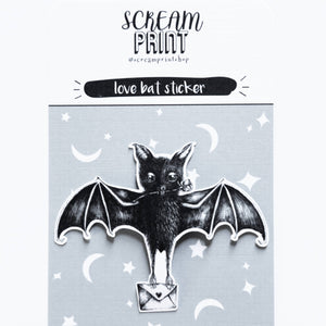 A black bat sticker with wings spread, holding a small silver envelope, mounted on a light gray backing card. The card has white stars and crescent moons and reads 'SCREAM PRINT' and 'love bat sticker'.