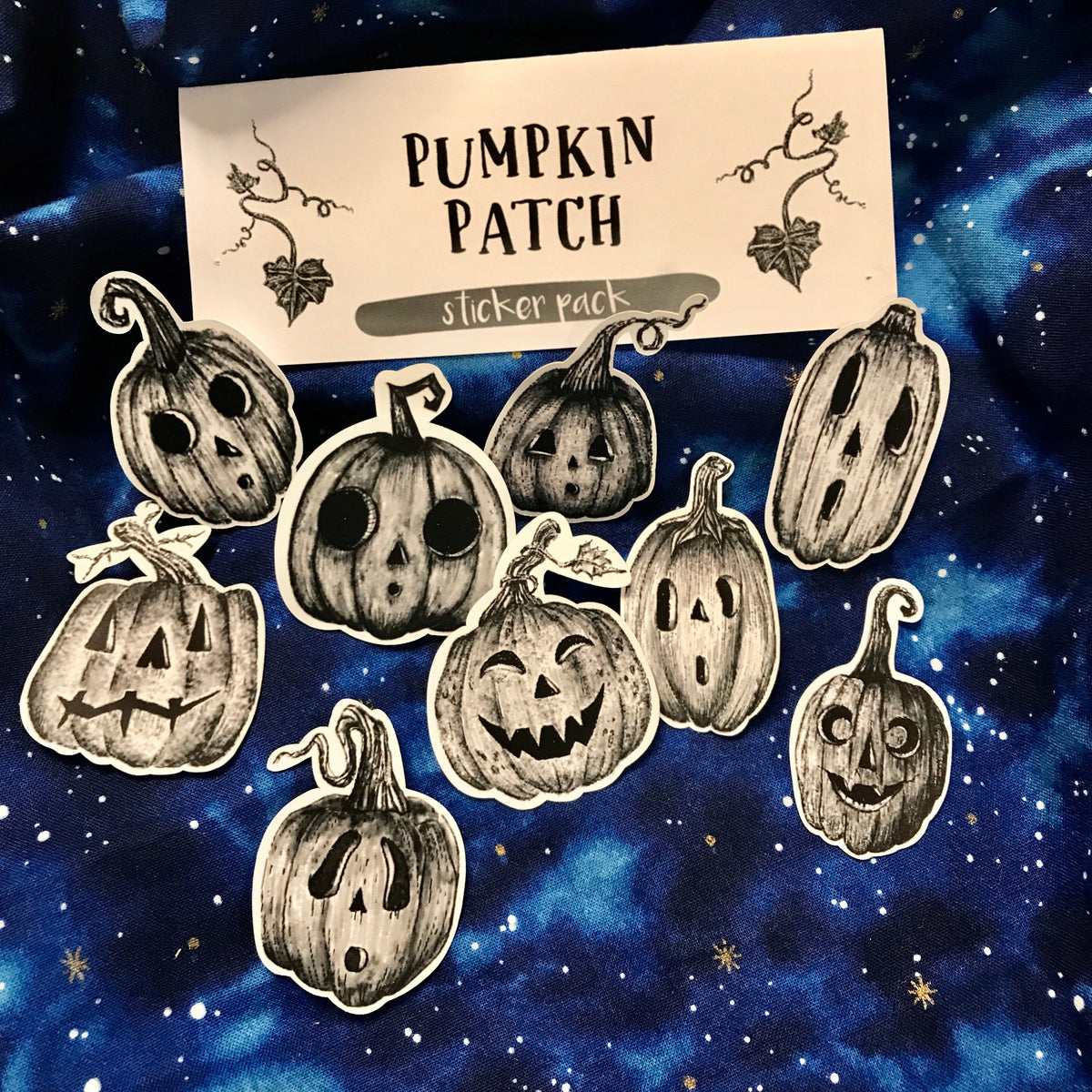 A grouping of nine black and white hand-drawn jack-o-lantern stickers with a branded card that says "Pumpkin Patch Sticker Pack