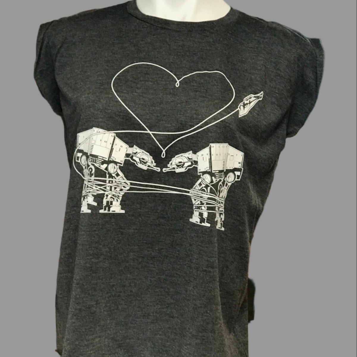 Dark gray t-shirt with Love AT-AT First Sight design on a mannequin in a store setting.