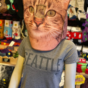 Mannequin wearing a cat face mask with a colorful store background. The shirt they are wearing is gray and it says "This Says Seattle On it." The perfect souvenir.