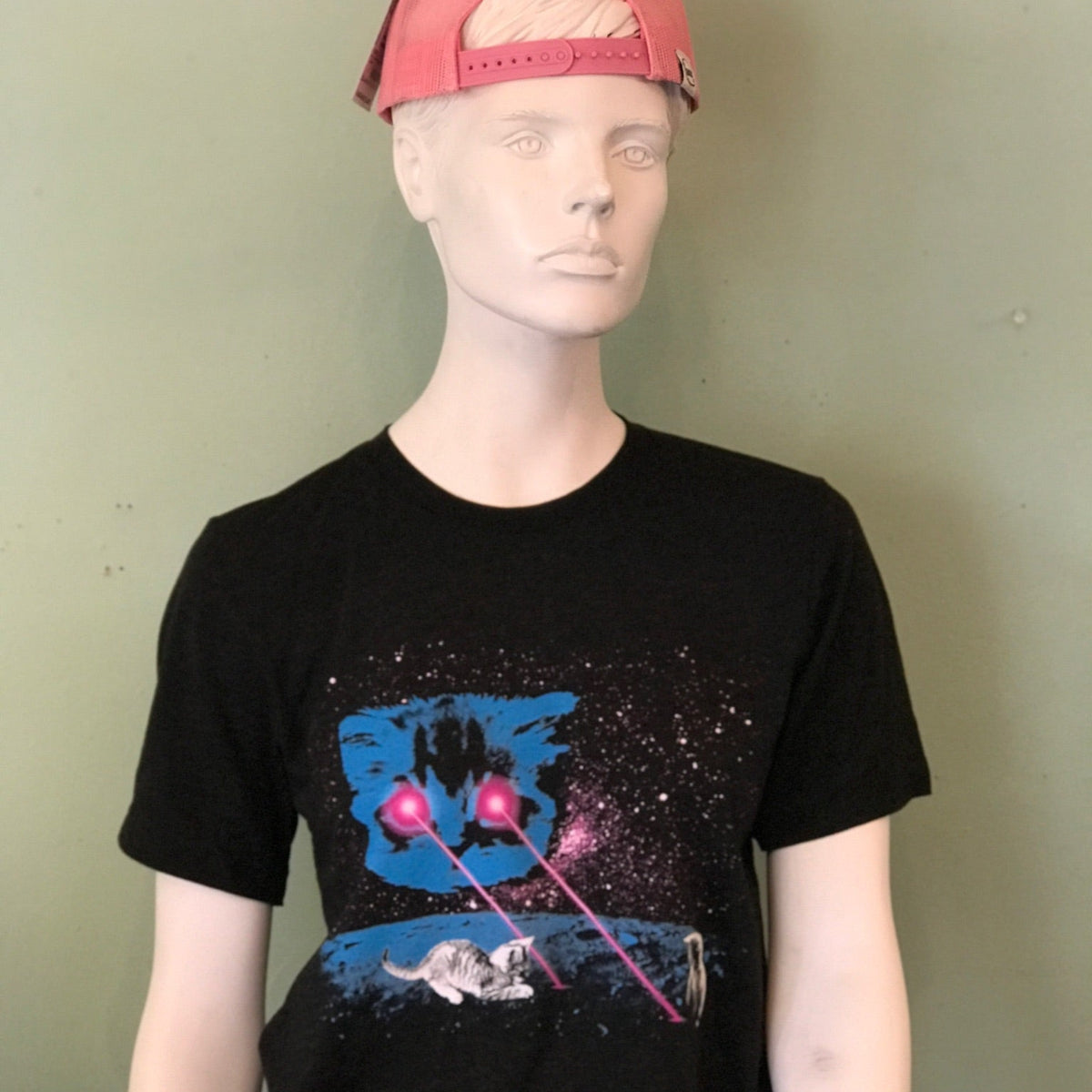 Mannequin wearing a black t-shirt with a graphic design on a plain background