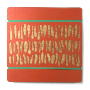 Orange wooden flower press with engraved leaf shapes and green rubber bands