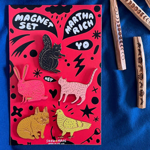 Set of magnets and palo santo on a blue fabric background. 