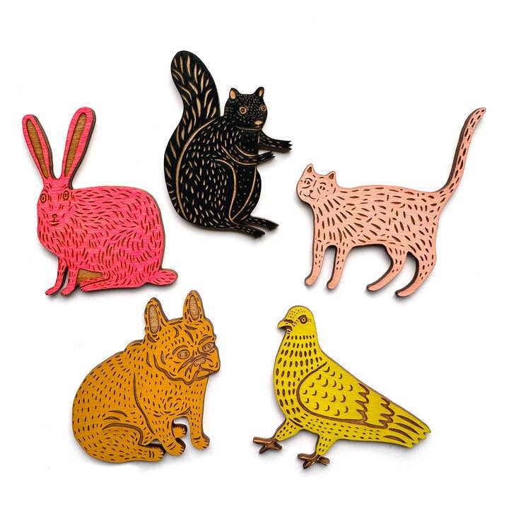 Set of colorful animal pins including a rabbit, squirrel, cat, dog, and bird on a white background.