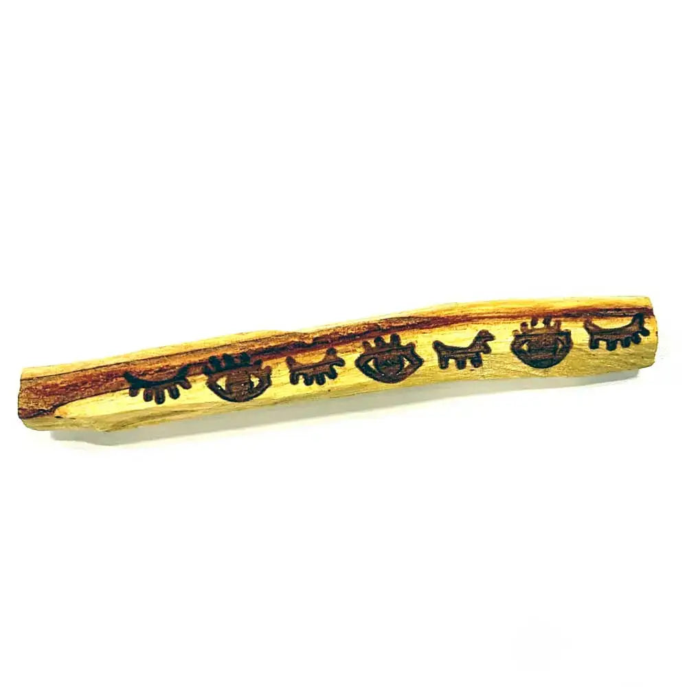 Wooden stick with engraved designs on a white background
