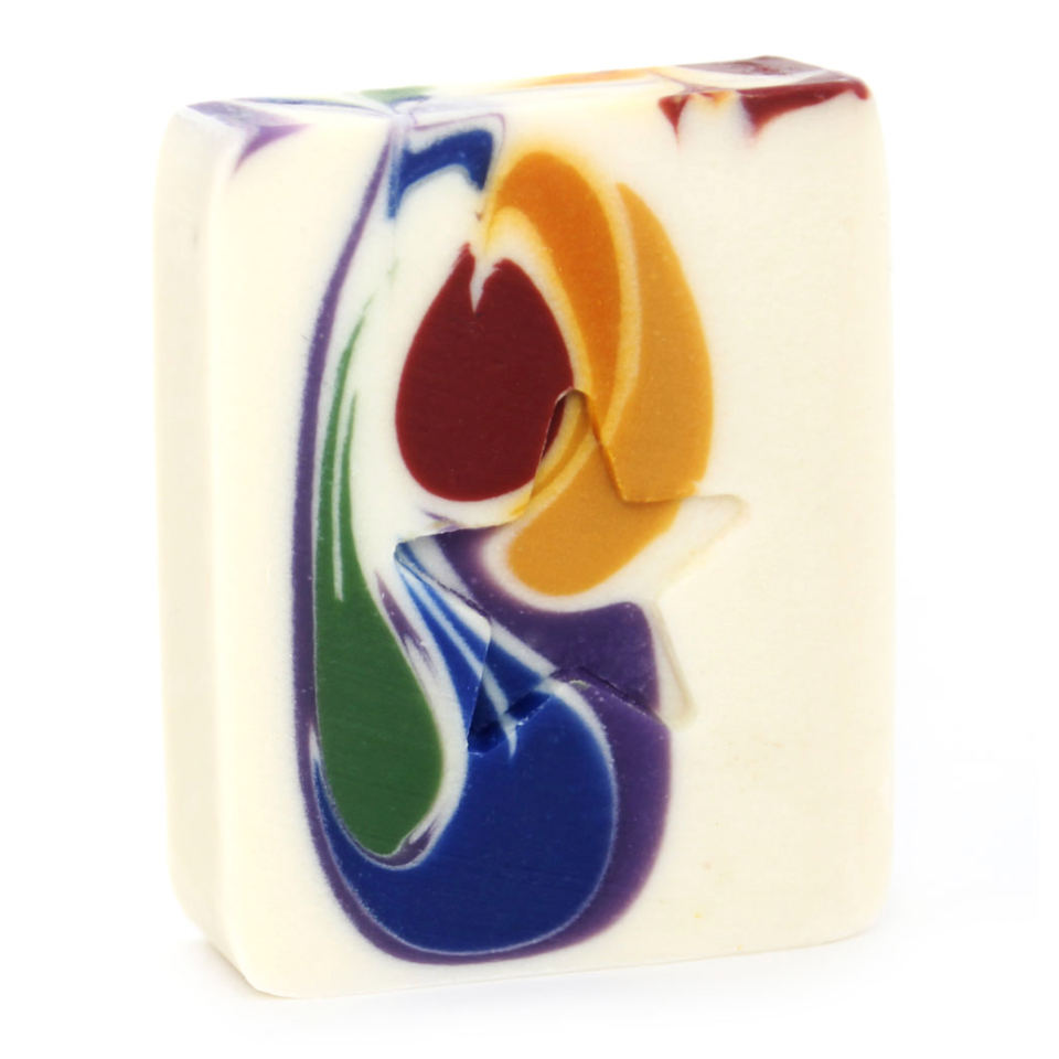 A bar of handmade soap with a multicolored design featuring swirls of blue, orange, and green hues on a white base.