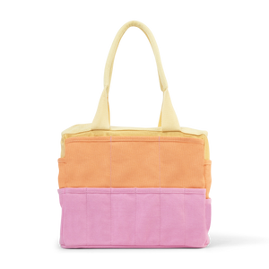 Color-blocked tote bag with yellow, orange, and pink sections on a white background