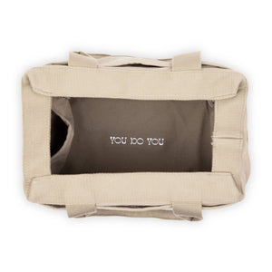 Beige tote bag with 'YOU DO YOU' text on a white background