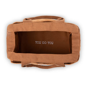 Brown bag with 'YOU DO YOU' text on a white background
