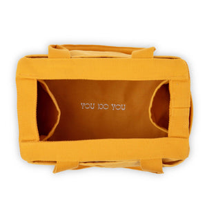 Yellow bag with 'YOU DO YOU' branding on a white background