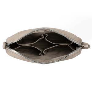 Beige pouch with a zipper on a black background