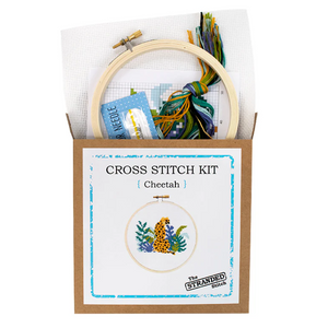 Cross stitch kit with hoop, thread, and pattern card on a white background. The front shows a cheetah surrounded by plants. 