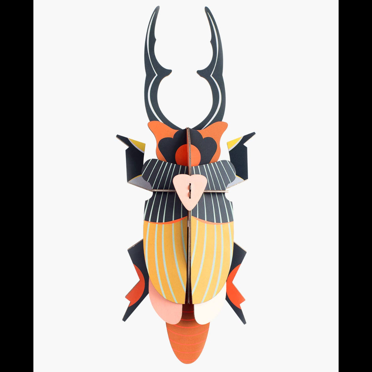 Cardboard sculpture of a giant stag beetle against a white background. 