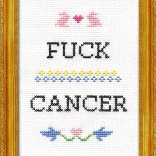 Cross-stitched design with 'F**K CANCER' text and decorative elements in a gold frame.