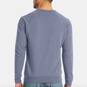 Person wearing a blue sweatshirt on a white background. 