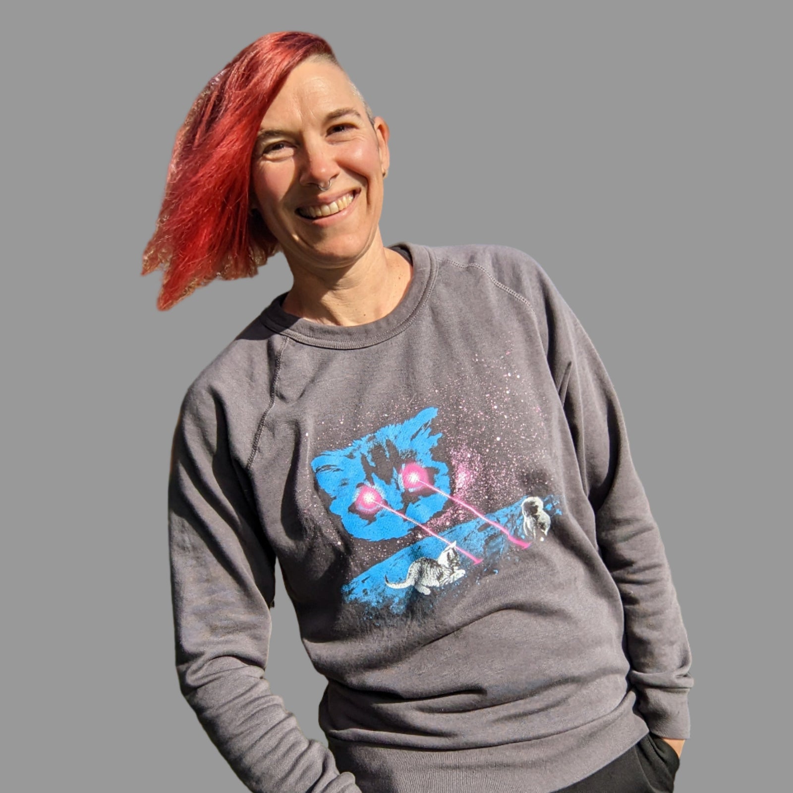 Person wearing a gray sweatshirt with our Meta Laser Cat design.