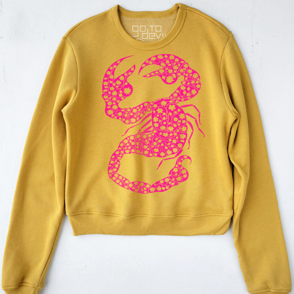 Yellow sweatshirt with a pink scorpion design on a white background.