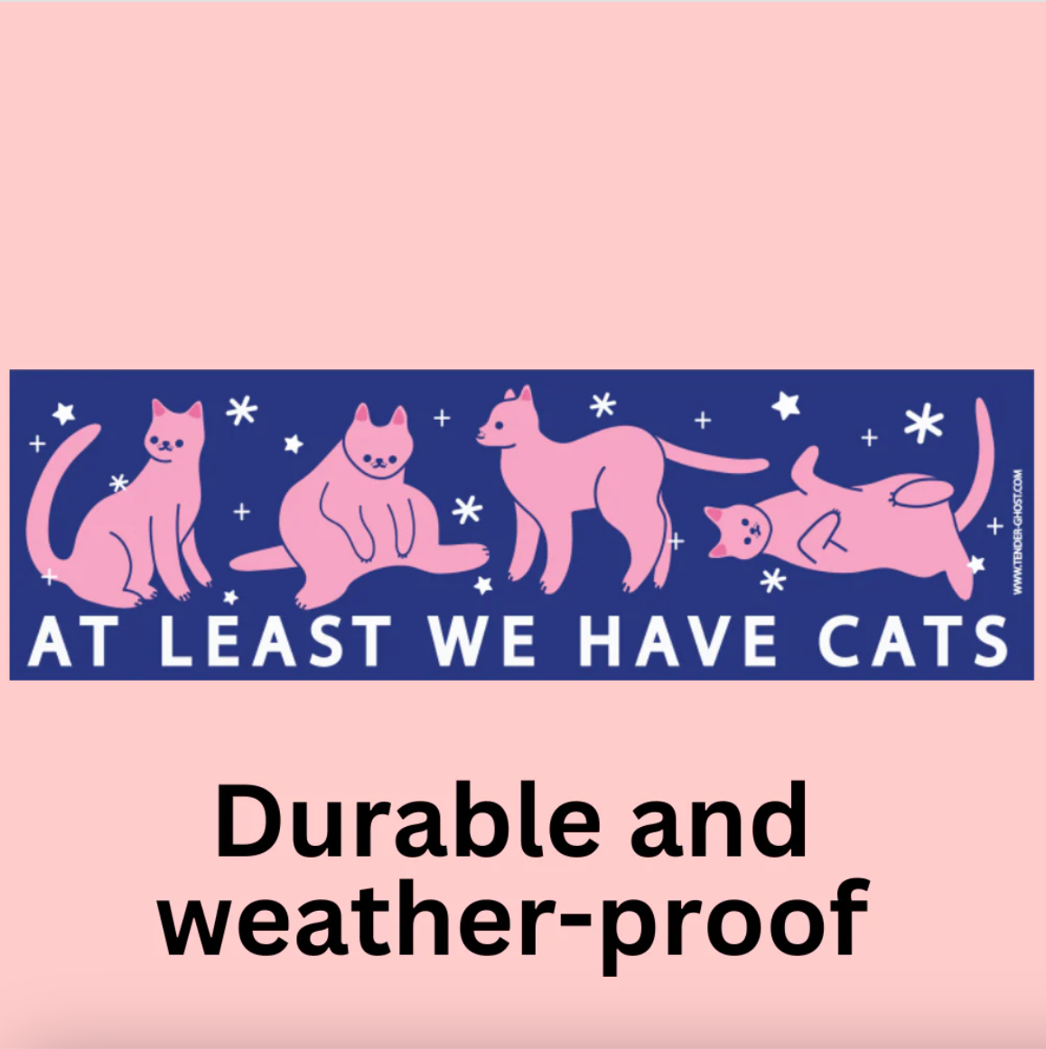 Bumper sticker of four pink cats in different poses with text "at least we have cats" on a dark blue background