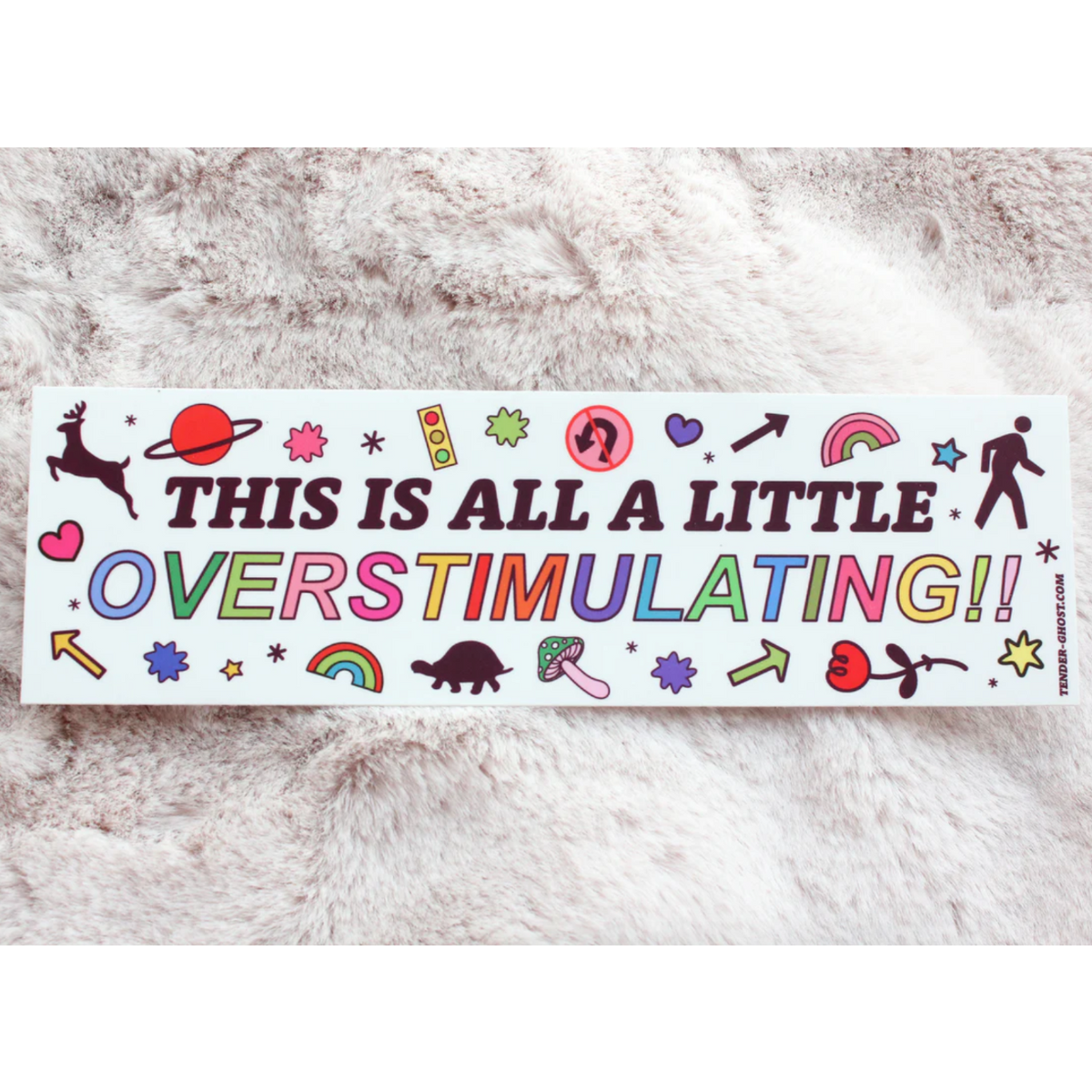 Bumper sticker with various doodles and text that says "This is all a little overstimulating!!"