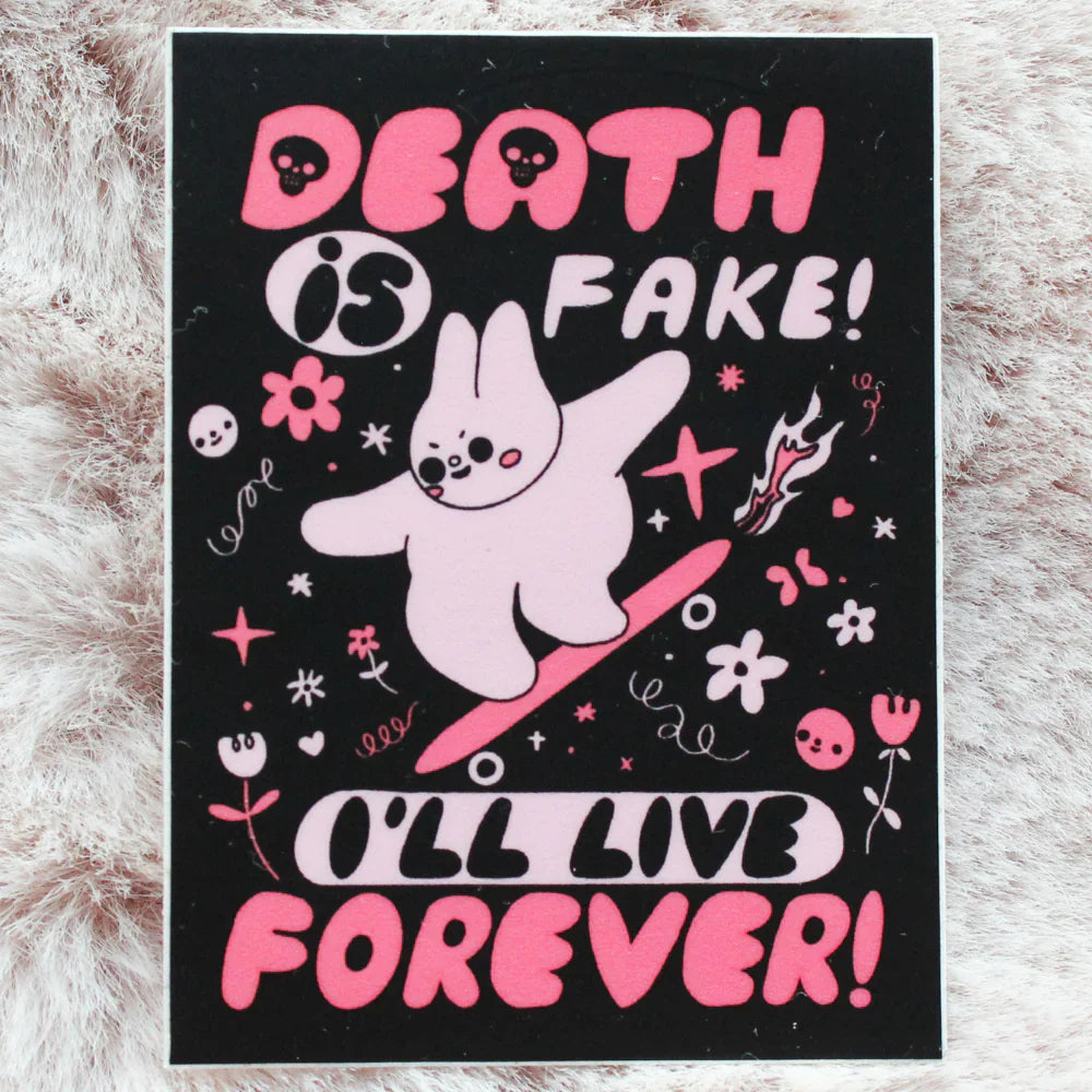 A sticker with a bunny riding a skateboard and text that says "Death is fake! I'll live forever!"