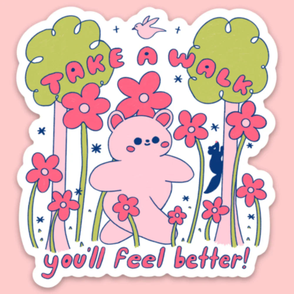 A sticker of a bear walking through a forest and field of flowers with pink text that says "Take a walk you'll feel better"