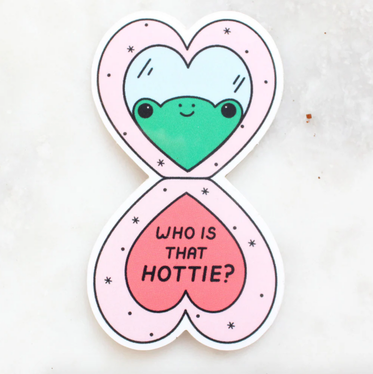 Heart-shaped sticker with a green frog and 'Who is that hottie?' text on a white background