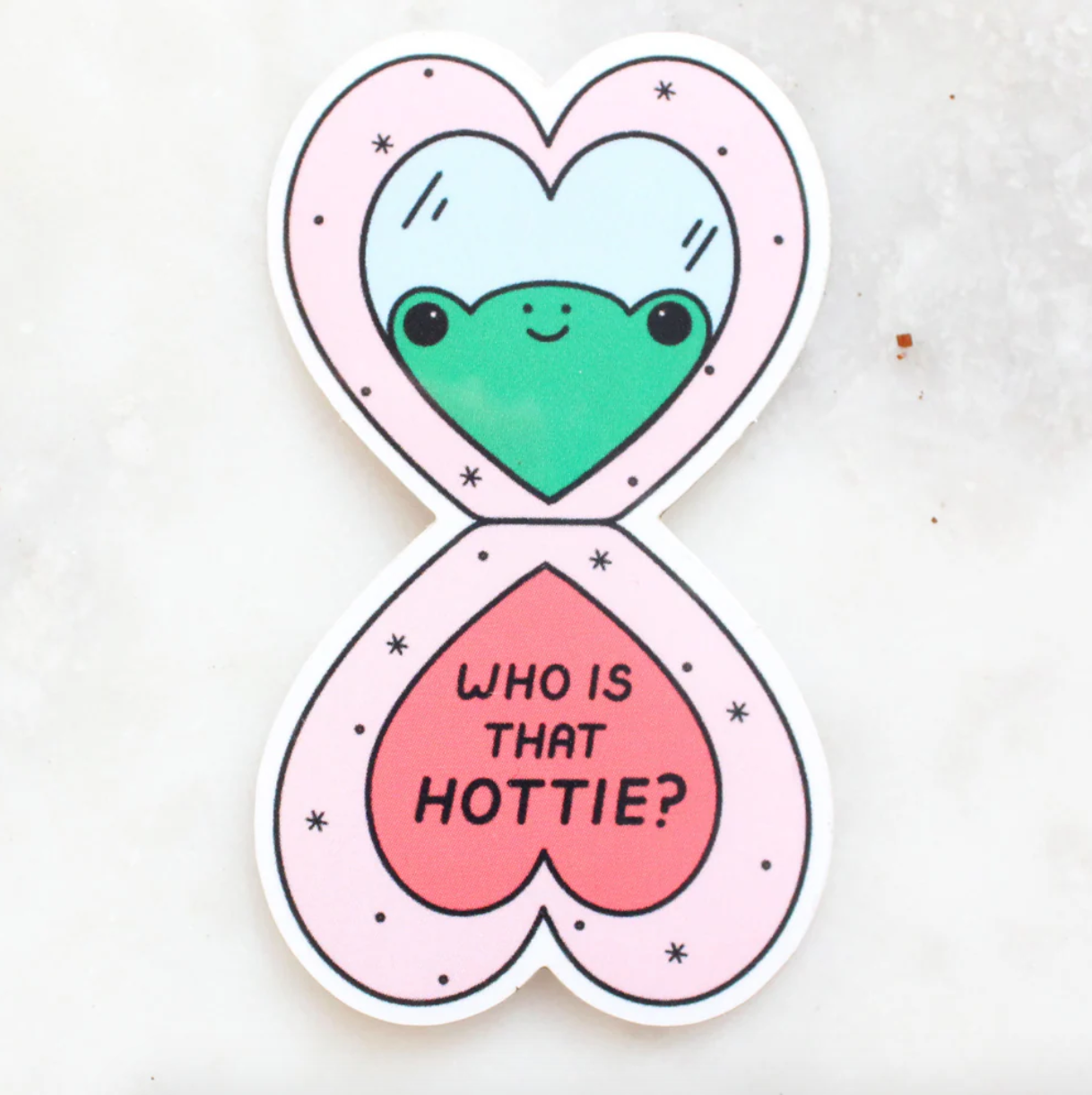 Heart-shaped sticker with a green frog and 'Who is that hottie?' text on a white background